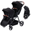 Black tandem stroller with reversible seats, adjustable canopies, one-hand fold, large storage basket, for newborns and toddlers.
