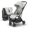 UPPAbaby Minu V3 travel stroller in greyson, charcoal mélange with carbon frame and saddle leather, showing a lightweight, compact design