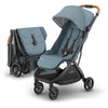 UPPAbaby Minu V3 lightweight travel stroller in Greyson, charcoal mélange with carbon frame and saddle leather, showing folded design