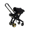 Doona car seat and stroller in slate green, all-in-one travel system with adjustable handle and safety harness for infants.