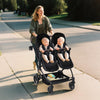 Lightweight double stroller for twins with reclining seats, adjustable canopy, and 5-point harness, featuring a high landscape design.
