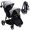 Dark grey tandem double stroller for newborn and toddler, with reversible seats, adjustable canopy, 5-point harness, and large storage basket.