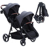 Dark grey tandem double stroller for twins with foldable design, reversible seats, adjustable canopy, 5-point harness, and large storage basket.