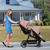 Dark grey tandem double stroller for twins with reversible seats, adjustable canopy, 5-point harness, large storage, and one-hand fold.