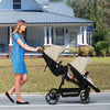 Double tandem stroller for newborn and toddler with reversible seats, safety harness, adjustable backrests, canopy, and storage basket.