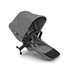 Bugaboo Donkey 6 sibling seat in cocoa brown for side-by-side double stroller conversion, shown installed on stroller frame.