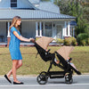 Dark grey tandem double stroller for newborn and toddler, with reversible seats, adjustable canopy, 5-point harness, and large storage basket.